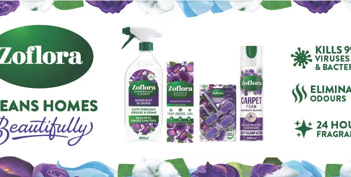Zoflora home cleaning products displayed on a white background with decorative purple and white flowers around the border. The products include a spray bottle, a bottle with a cap, and a carpet cleaner package.