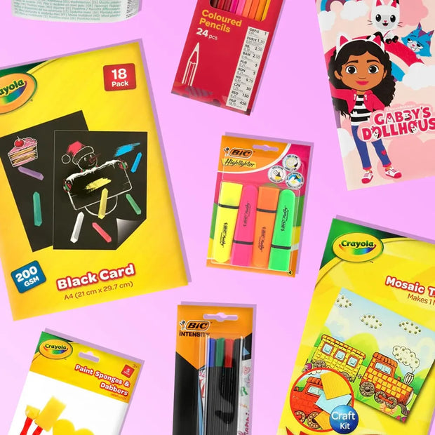 A flat-lay arrangement of multiple Crayola and BIC craft and coloring products on a solid pink background, including a black card craft kit, colored pencils, highlighters, paint sponge stickers, and a mosaic tile craft kit.