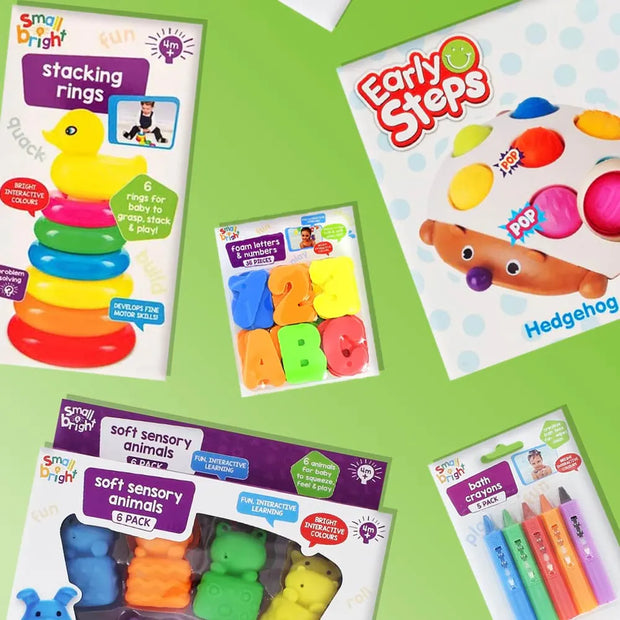 A flat lay of several colorful children's toy activity packages on a light green background. Visible products include stacking rings, number letters, hedgehog sensory play, soft sensory animals, and crayon drawing tools.
