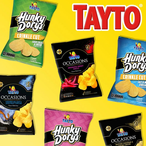 A promotional collage of six Tayto snack bags arranged on a bright yellow background, including Hunky Dorys Crinkle Cut and Occasions flavors. The bags are green, black, blue, pink, and dark brown/black, with the large red and white Tayto logo at the top right.